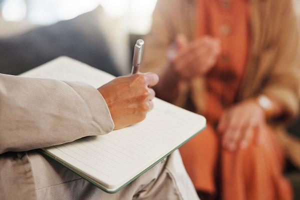 therapist talking with lady in background