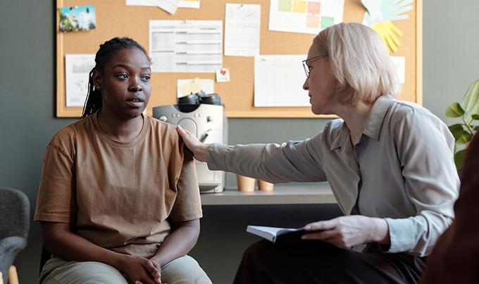 Lady talking with younger black woman