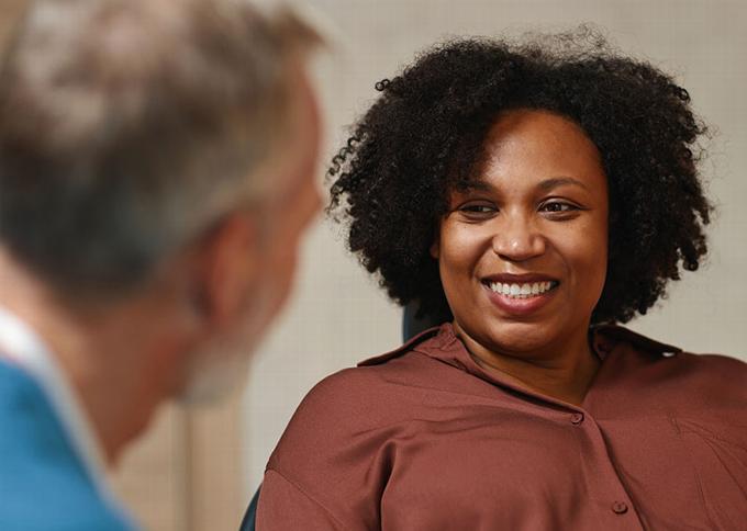 Lady smiling at older man just in frame